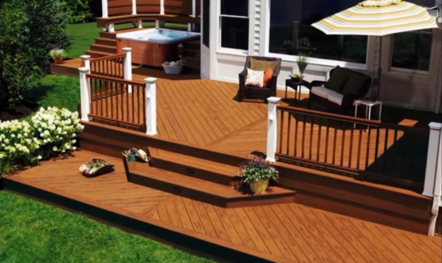 Multi-level brown composite deck with diagonal boards, a raised hot tub level with built-in bench seating, white rail posts and wide steps down to a lower level